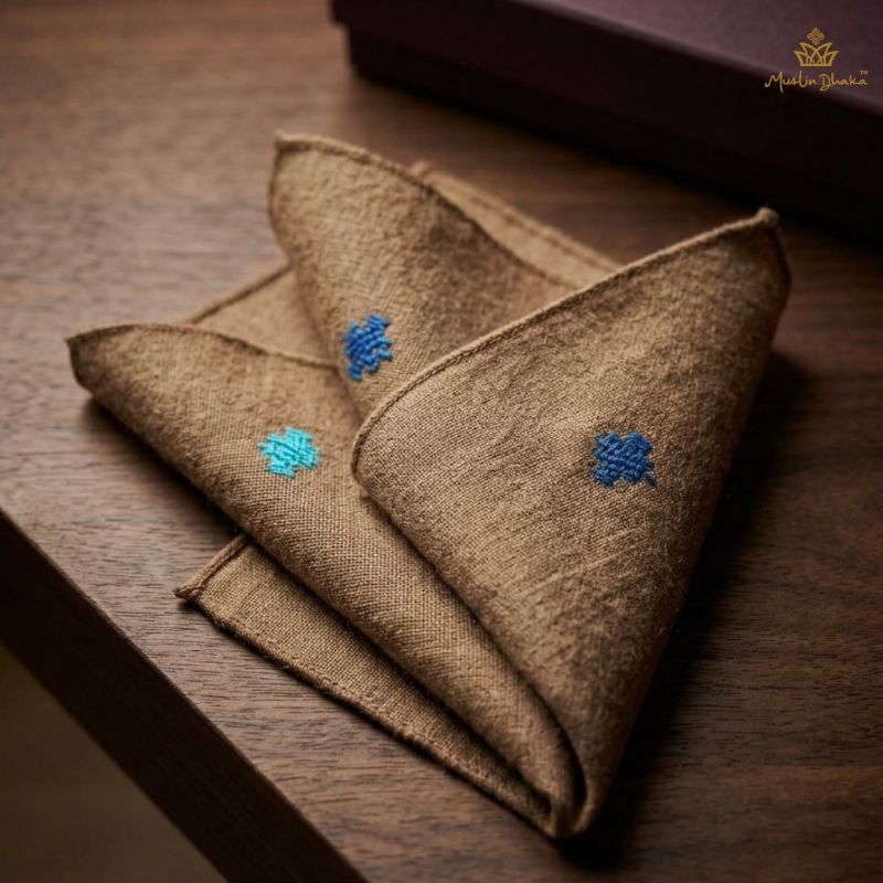 Folded Cervelt pocket square in natural fawn with blue cotton motifs