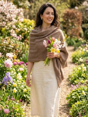 Woman wearing the handwoven Cervelt Signature Shawl in a spring garden